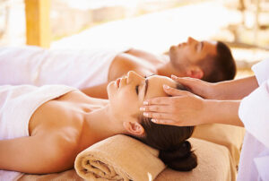 Young couple enjoying a massage seaside